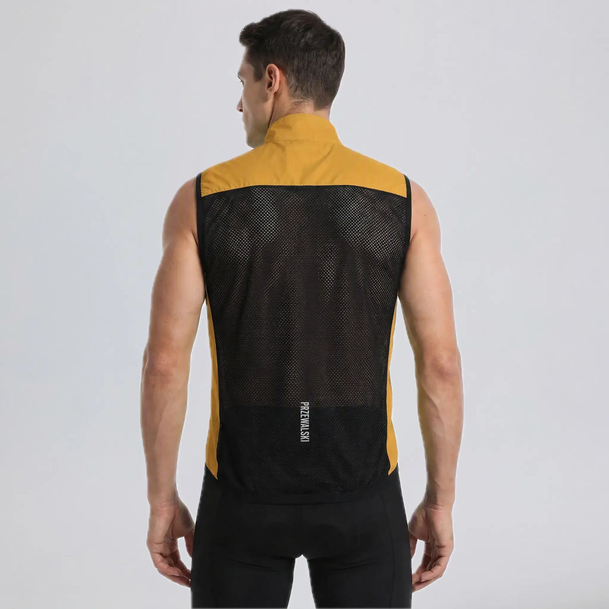Back view of a model wearing an orange men's windproof cycling vest with a breathable mesh panel.