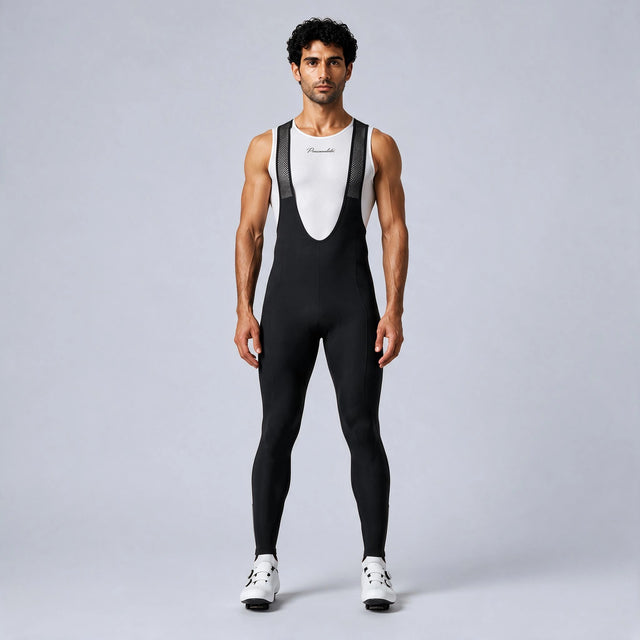 Front view of a model wearing black men's winter fleece road cycling bib tights.