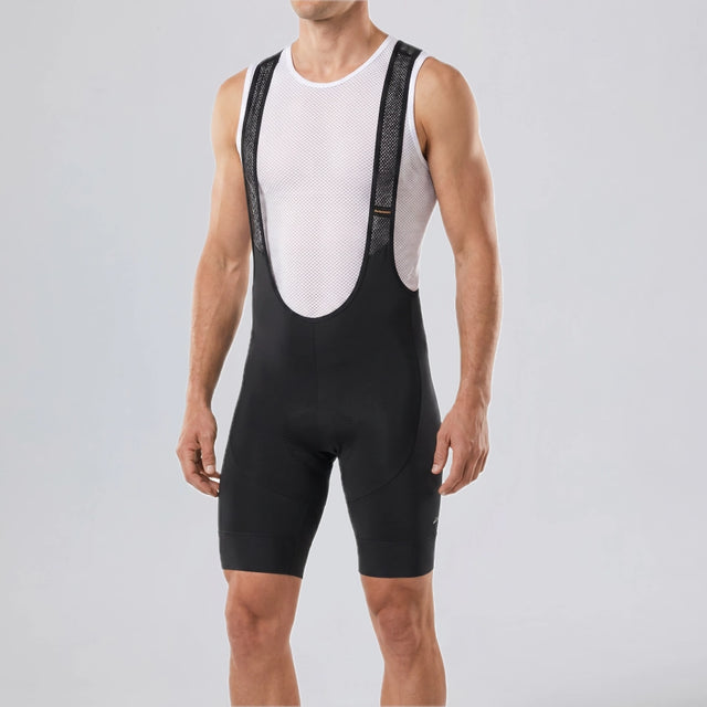 Front close-up of a model wearing black men's gravel endurance bib shorts.