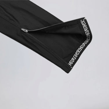 Close-up of the ankle zipper and leg gripper on men's winter fleece cycling bib tights.