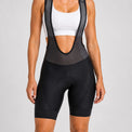 Front close-up of a model wearing black women's road cycling bib shorts.