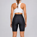 Back view of a model wearing black women's road cycling shorts.