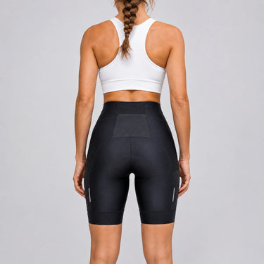 Back view of a model wearing black women's road cycling shorts.