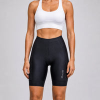 Front close-up of a model wearing black women's road cycling shorts.
