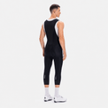 Back three-quarter view of a model wearing black men's classic 3/4 cycling bib shorts.