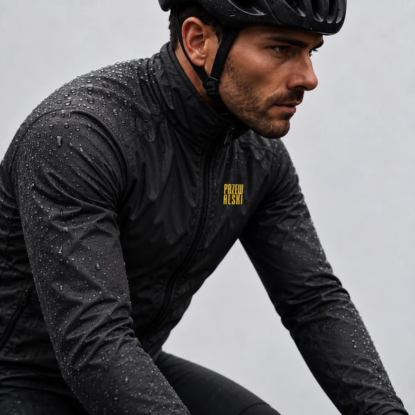 Cyclist wearing a black lightweight windproof cycling jacket in wet conditions