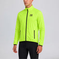 Front view of a model wearing the green men's lightweight windproof cycling jacket.