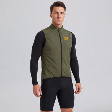 Man wearing a green windproof cycling vest over a long-sleeve jersey