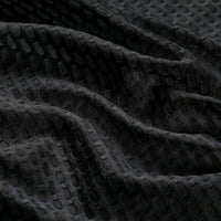 Close-up of the breathable mesh fabric on a black women's windproof cycling vest.