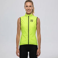 Front view of a model wearing a bright green women's windproof cycling vest.