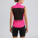 Back view of a model wearing a rose red women's windproof cycling vest with rear pocket.