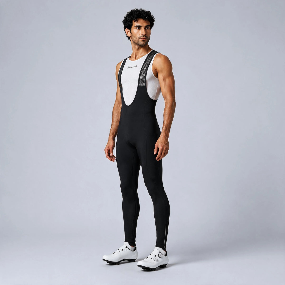 Front three-quarter view of a model wearing black men's winter fleece road cycling bib tights.