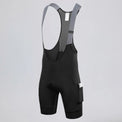 Front three-quarter view of black men's off-road bib shorts with gray straps and a side pocket.