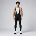 Front view of a model wearing black men's winter thermal road cycling bib tights.