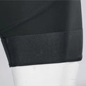 Close-up of the mesh leg gripper on black men's gravel endurance bib shorts.