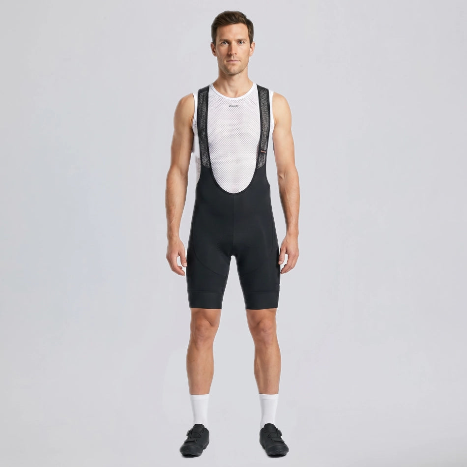 Full-length front view of a model wearing black men's gravel endurance bib shorts.