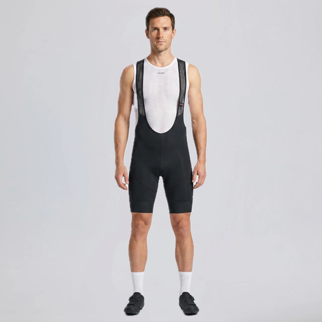 Full-length front view of a model wearing black men's gravel endurance bib shorts.