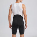 Back view of a model wearing black men's MTB endurance bib shorts.
