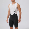 Front three-quarter view of a model wearing black men's MTB endurance bib shorts.
