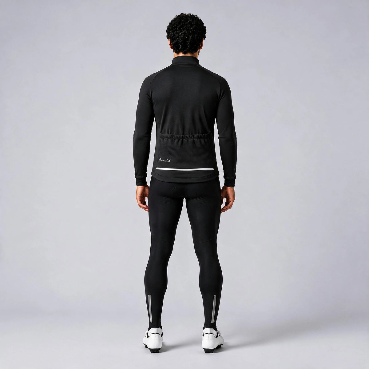 Back view of a model wearing a black men's winter cycling jacket.
