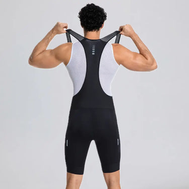 Rear view of a model stretching the shoulder straps of black men's cargo cycling bib shorts.