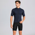 Male cyclist wearing Przewalski men's navy short sleeve cycling jersey with black bib shorts