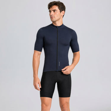 Male cyclist wearing Przewalski men's navy short sleeve cycling jersey with black bib shorts
