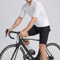 Male cyclist wearing Przewalski white short sleeve cycling jersey on road bike