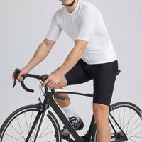 Male cyclist wearing Przewalski white short sleeve cycling jersey on road bike