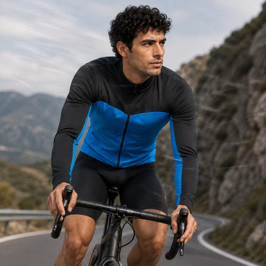 Cyclist wearing a blue and black winter fleece cycling jacket on a mountain road